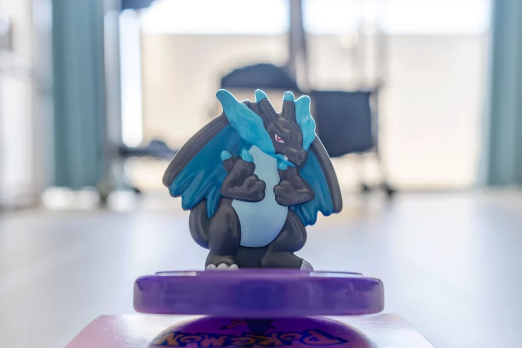 It's a Pokémon toy, Mega Charizard X spinning top, from Japan McDonald's Happy Meal. It's great for kids to play with while enjoying their meal.
