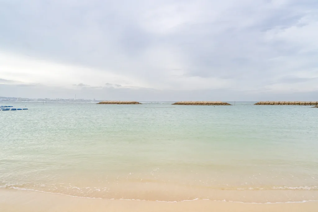 The cloudy view of Sunset Beach, with high waves in the distant sea.